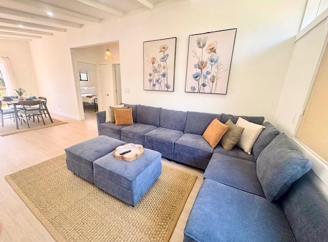 living area featuring light wood-style floors, beam ceiling, recessed lighting, and baseboards
