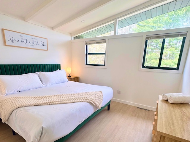 bedroom with light wood finished floors and baseboards