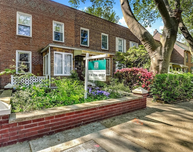 exterior space featuring brick siding