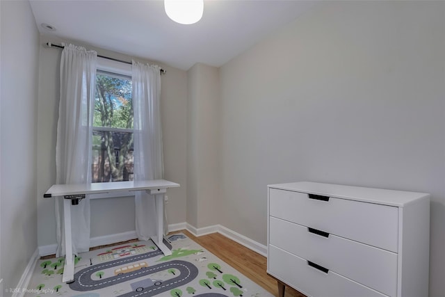 home office with baseboards and light wood-style flooring