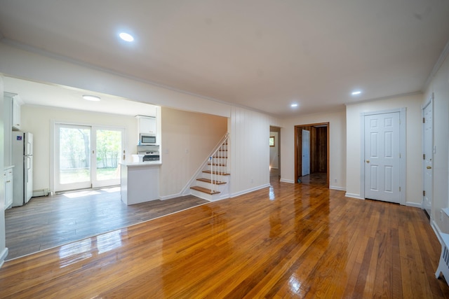 6 Pompano Ln, Massapequa Park, NY 11762 - unfurnished living room with crown molding, stairway, wood-type flooring, recessed lighting, and baseboards