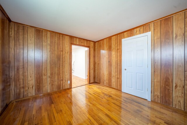 6 Pompano Ln, Massapequa Park, NY 11762 - empty room featuring hardwood / wood-style floors and wooden walls