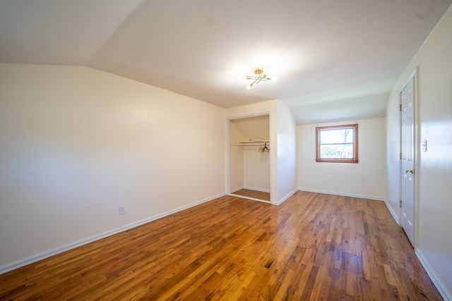 6 Pompano Ln, Massapequa Park, NY 11762 - unfurnished bedroom featuring lofted ceiling, wood finished floors, a closet, and baseboards