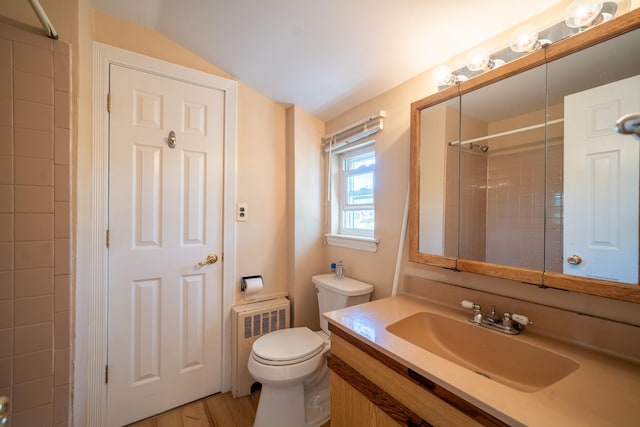 6 Pompano Ln, Massapequa Park, NY 11762 - bathroom featuring radiator, toilet, vanity, vaulted ceiling, and wood finished floors