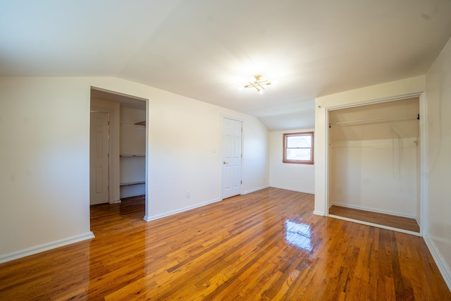 6 Pompano Ln, Massapequa Park, NY 11762 - unfurnished bedroom with a closet, lofted ceiling, hardwood / wood-style floors, and baseboards