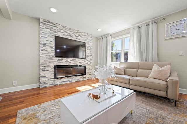 80-21 209th St, Hollis Hills, NY 11427 - living room with recessed lighting, baseboards, a stone fireplace, and wood finished floors