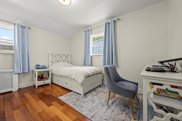 80-21 209th St, Hollis Hills, NY 11427 - bedroom featuring baseboards, vaulted ceiling, radiator heating unit, and wood finished floors