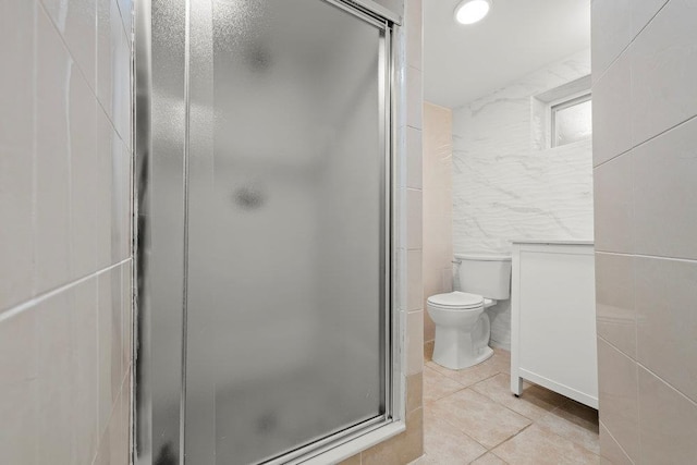 80-21 209th St, Hollis Hills, NY 11427 - bathroom with a stall shower, tile walls, tile patterned floors, and toilet