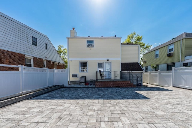 80-21 209th St, Hollis Hills, NY 11427 - back of house featuring a chimney, a patio area, and a fenced backyard