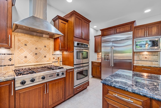 37 Shallow Stream Rd, Carmel, NY 10512 - kitchen featuring wall chimney range hood, built in appliances, recessed lighting, dark stone countertops, and backsplash