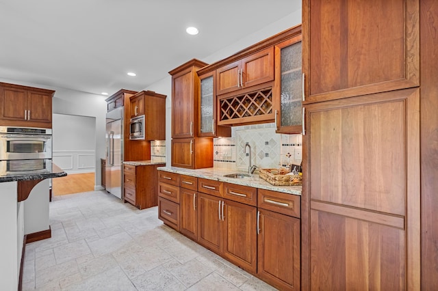 37 Shallow Stream Rd, Carmel, NY 10512 - kitchen with built in appliances, a sink, brown cabinetry, stone tile floors, and recessed lighting