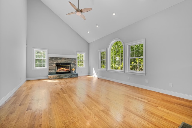 37 Shallow Stream Rd, Carmel, NY 10512 - unfurnished living room featuring high vaulted ceiling, a ceiling fan, a stone fireplace, baseboards, and light wood-style floors