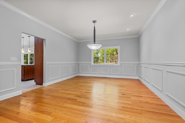 37 Shallow Stream Rd, Carmel, NY 10512 - unfurnished dining area featuring light wood-type flooring, crown molding, a decorative wall, and a wainscoted wall