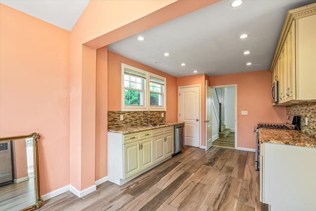kitchen with recessed lighting, a sink, appliances with stainless steel finishes, and decorative backsplash