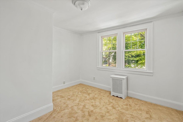 unfurnished room featuring carpet flooring, crown molding, and baseboards