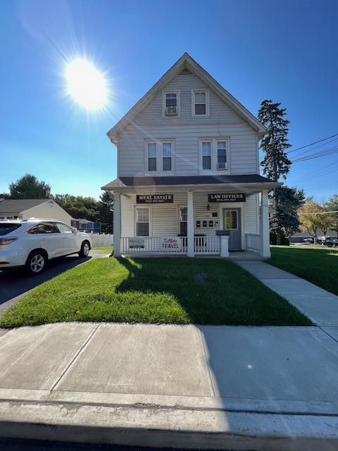 317 Elwood Ave, Hawthorne, NY 10532 - view of front of property featuring covered porch and a front lawn