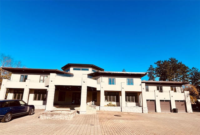 contemporary house featuring stucco siding and a balcony