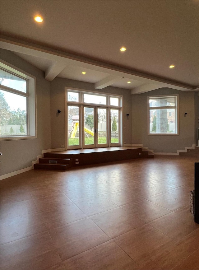 empty room featuring beam ceiling, recessed lighting, baseboards, and tile patterned floors