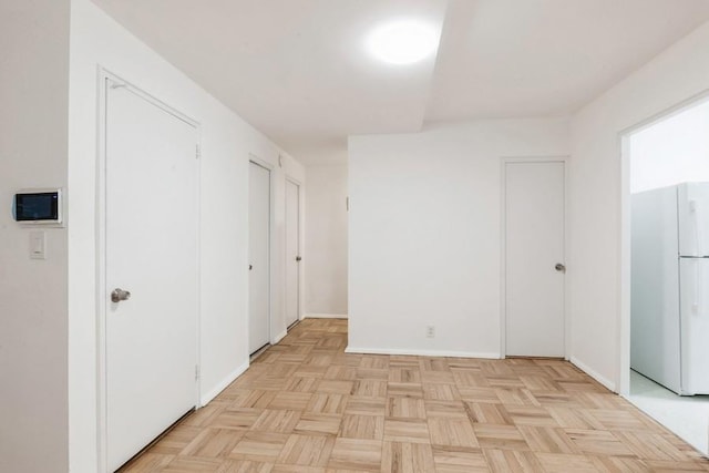 21-55 34th Ave Unit 3C, Long Island City, NY 11106 - unfurnished bedroom with freestanding refrigerator and baseboards