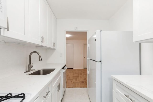 21-55 34th Ave Unit 3C, Long Island City, NY 11106 - kitchen with freestanding refrigerator, a sink, white cabinetry, light stone countertops, and stove