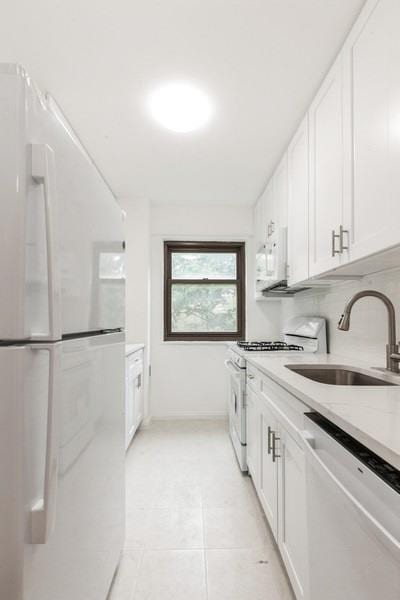21-55 34th Ave Unit 3C, Long Island City, NY 11106 - laundry room with light tile patterned floors and baseboards