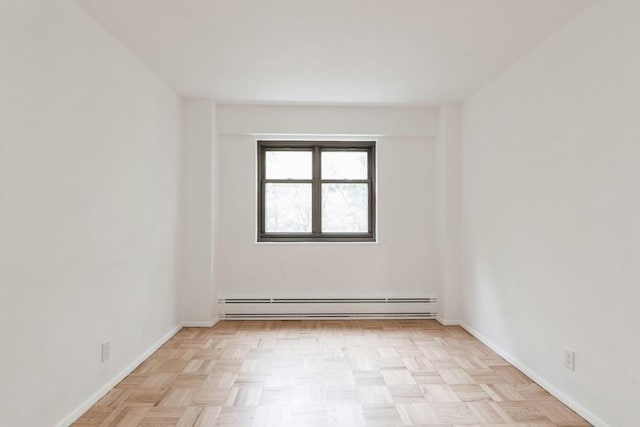 21-55 34th Ave Unit 3C, Long Island City, NY 11106 - unfurnished room with a baseboard radiator and baseboards