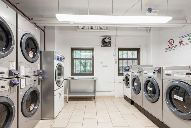 21-55 34th Ave Unit 3C, Long Island City, NY 11106 - shared laundry with stacked washing machine and dryer, washing machine and dryer, plenty of natural light, and light tile patterned floors