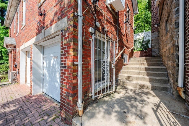 view of property exterior with brick siding and an attached garage
