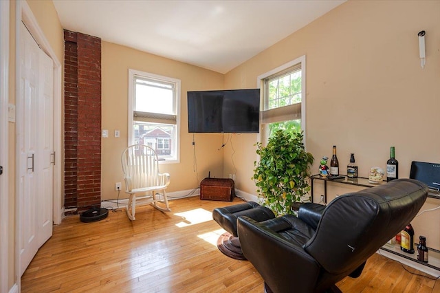 living room with light wood-type flooring and baseboards