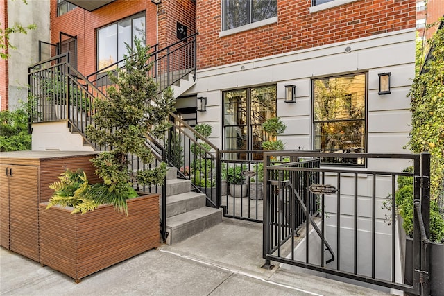 property entrance with brick siding and a gate