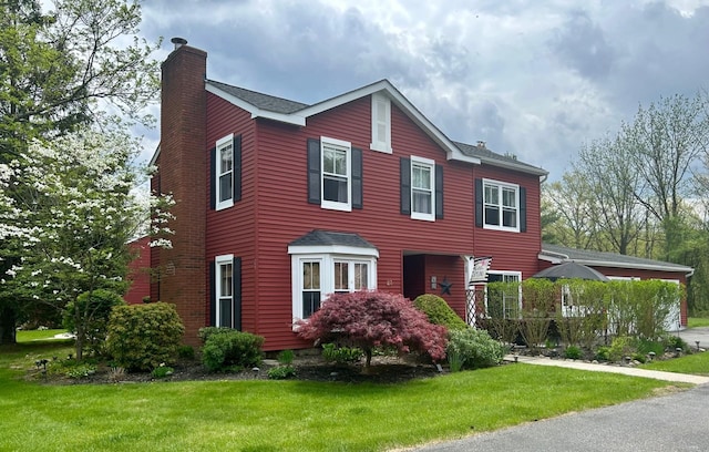 23 Candlestick Ct, Warwick, NY 10990 - colonial inspired home with a chimney, a front lawn, and a shingled roof