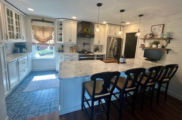 23 Candlestick Ct, Warwick, NY 10990 - kitchen with open shelves, appliances with stainless steel finishes, custom exhaust hood, white cabinetry, and tasteful backsplash