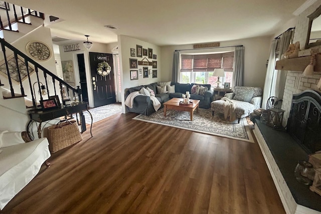 23 Candlestick Ct, Warwick, NY 10990 - living area with wood finished floors, stairs, and a brick fireplace