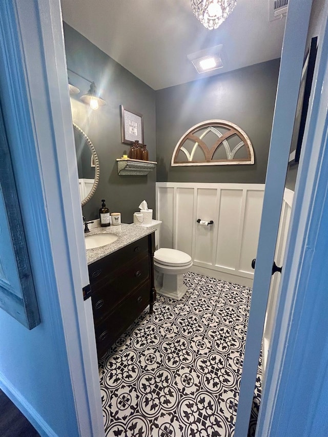 23 Candlestick Ct, Warwick, NY 10990 - bathroom with vanity, toilet, and a wainscoted wall