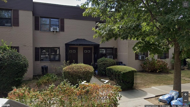 townhome / multi-family property with brick siding