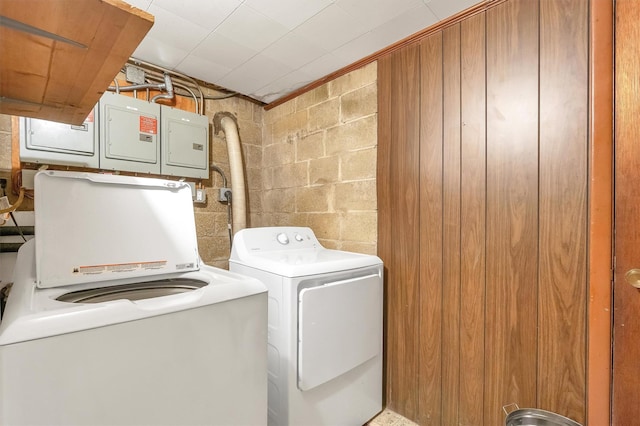 laundry area with laundry area, separate washer and dryer, and concrete block wall