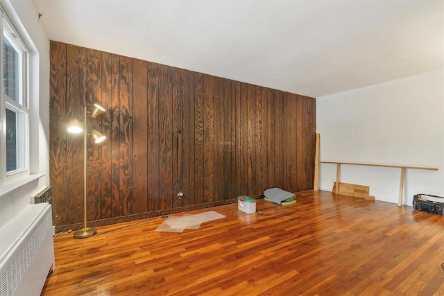 spare room featuring radiator heating unit and wood finished floors