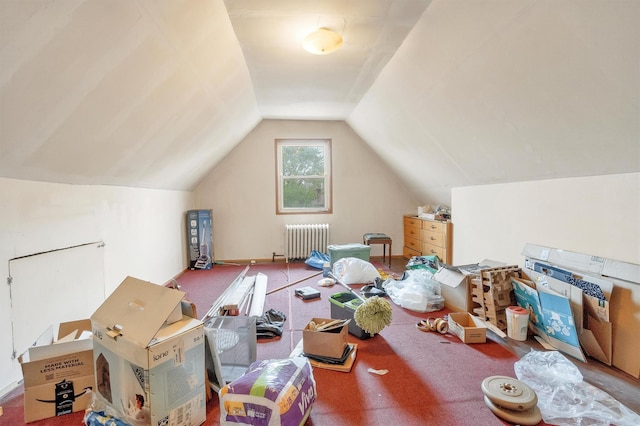 bonus room with lofted ceiling, radiator, and carpet flooring