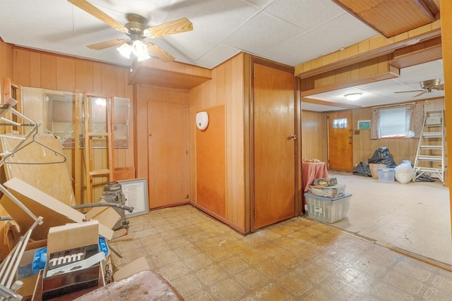 interior space with tile patterned floors and wood walls