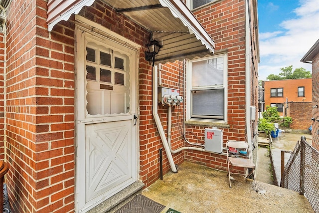 entrance to property featuring brick siding