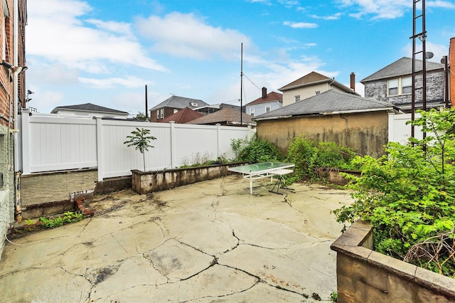 view of patio with a residential view and a fenced backyard