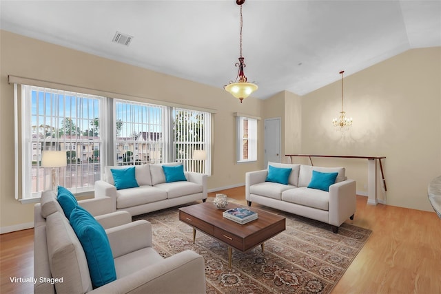 606 Narragansett Villas Dr Unit 606, Lindenhurst, NY 11757 - living area featuring a chandelier, wood finished floors, vaulted ceiling, and baseboards