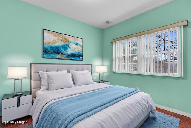 606 Narragansett Villas Dr Unit 606, Lindenhurst, NY 11757 - bedroom featuring baseboards and wood finished floors
