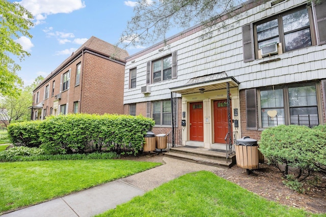70-07 E Park Dr Unit A, Kew Garden Hills, NY 11367 - multi unit property with brick siding, a front lawn, cooling unit, and mansard roof