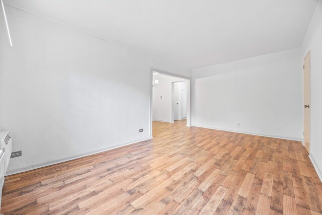 70-07 E Park Dr Unit A, Kew Garden Hills, NY 11367 - spare room featuring light wood-type flooring and baseboards