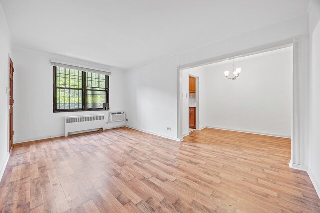 70-07 E Park Dr Unit A, Kew Garden Hills, NY 11367 - spare room with radiator, a chandelier, light wood-style flooring, and baseboards