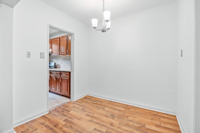 70-07 E Park Dr Unit A, Kew Garden Hills, NY 11367 - unfurnished dining area with ornamental molding, light wood-style flooring, a chandelier, and baseboards