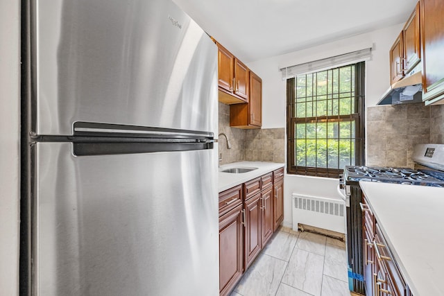70-07 E Park Dr Unit A, Kew Garden Hills, NY 11367 - kitchen featuring appliances with stainless steel finishes, radiator heating unit, a sink, light countertops, and backsplash