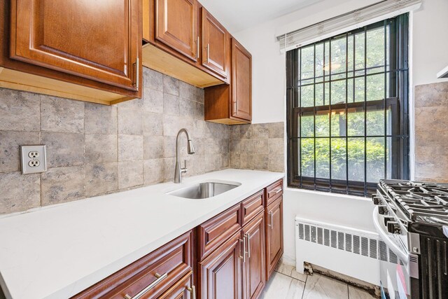 70-07 E Park Dr Unit A, Kew Garden Hills, NY 11367 - kitchen featuring a sink, radiator, plenty of natural light, and light countertops