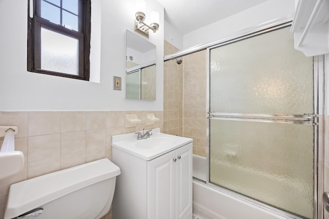 70-07 E Park Dr Unit A, Kew Garden Hills, NY 11367 - full bath with tile walls, toilet, shower / bath combination with glass door, and vanity